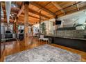 Spacious loft-style living area with exposed wooden beams and hardwood floors at 2955 Inca St # 2L, Denver, CO 80202