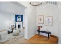 Bright entryway with hardwood floors, a bench seat, and decor leading to living room with fireplace at 1333 N Lafayette St, Denver, CO 80218