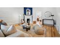 Open living room featuring a fireplace, hardwood floors, and stylish, modern decor at 1333 N Lafayette St, Denver, CO 80218
