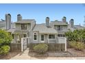Charming townhome featuring a fenced front yard and unique architectural details at 494 Owl Dr # 4, Louisville, CO 80027