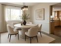Inviting dining room with a modern table, stylish chairs, and soft natural light at 7753 W Plymouth S Pl, Littleton, CO 80128