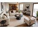 Spacious living area with comfortable seating, modern decor, and an open flow to the kitchen at 7753 W Plymouth S Pl, Littleton, CO 80128