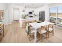 Bright kitchen featuring white cabinets, stainless steel appliances, and a breakfast bar at 21104 E 63Rd Dr, Aurora, CO 80019