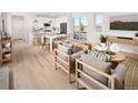 Bright and open-concept living room and dining area with stylish furnishings and modern decor at 21104 E 63Rd Dr, Aurora, CO 80019