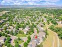 An aerial shot of a neighborhood with lush greenery and a red arrow pointing to the property at 5309 W Hoover Dr, Littleton, CO 80123