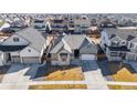 Beautiful aerial view of home nestled in a community with well-maintained lawns at 10976 Lewiston St, Commerce City, CO 80022