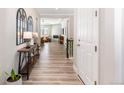 Entryway features light gray walls, wood-look floors, and a view into the living room at 10976 Lewiston St, Commerce City, CO 80022