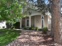 Beautiful single-story home with a covered front porch, stone accents, and well-maintained landscaping at 601 Clarendon Loop, Castle Pines, CO 80108