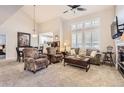Bright and airy living room with vaulted ceilings, fireplace, comfortable seating, and neutral decor at 601 Clarendon Loop, Castle Pines, CO 80108
