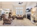 Inviting living room featuring a stone fireplace, plush seating, and ample natural light at 601 Clarendon Loop, Castle Pines, CO 80108