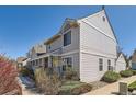 Charming multi-level home featuring tidy landscaping, a columned front porch, and muted siding at 7912 S Depew St # A, Littleton, CO 80128
