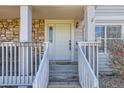 Inviting front entrance with a cozy porch, featuring stone accents and a well-maintained entryway at 7912 S Depew St # A, Littleton, CO 80128