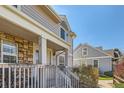 Inviting home exterior showcasing stone accents, a cozy front porch, and a well-manicured garden at 7912 S Depew St # A, Littleton, CO 80128