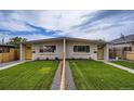 Charming duplex featuring well-maintained lawns, and inviting entrances, perfect for modern living at 3654 Fairfax St, Denver, CO 80207