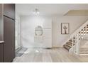 Sleek home entrance with modern decor, floating storage, and a staircase to the upper level at 2059 S Balsam St, Lakewood, CO 80227