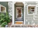 Inviting open door entrance with charming doormat, leading to a view of the home's interior at 2059 S Balsam St, Lakewood, CO 80227