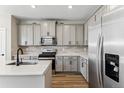 Stylish kitchen featuring stainless steel appliances, sleek cabinetry, and quartz countertops at 9376 Yampa Ct, Commerce City, CO 80022