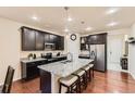 A kitchen features dark wood cabinets, granite counters, stainless steel appliances and a large center island at 7833 Bandit Dr, Castle Rock, CO 80108