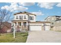 Charming two-story home with a three car garage and a welcoming front porch at 311 Portmeirion Ln, Castle Rock, CO 80104