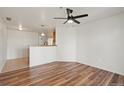 Open-concept living room featuring laminate flooring and modern ceiling fan at 5425 County Road 32 # 14, Mead, CO 80504