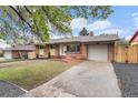 Attractive brick home with a spacious driveway and well-manicured front yard at 380 S Xanadu St, Aurora, CO 80012