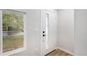 Modern white front door with glass accents and neutral-toned interior at 380 S Xanadu St, Aurora, CO 80012