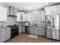Modern kitchen with stainless steel appliances, mosaic backsplash, and granite countertops at 3775 Balderas St, Brighton, CO 80601