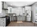 Modern kitchen with stainless steel appliances, mosaic backsplash, and granite countertops at 3775 Balderas St, Brighton, CO 80601