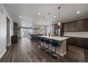 Stylish open-concept kitchen featuring a large center island, stainless appliances, and pendant lighting at 5611 Saddle Skirt St, Parker, CO 80134