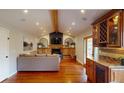 Open living room with fireplace and hardwood floors, connecting to the kitchen at 6278 E Euclid Ave, Centennial, CO 80111