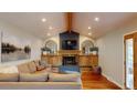 Cozy living room with a fireplace, beamed ceilings, and hardwood floors at 6278 E Euclid Ave, Centennial, CO 80111
