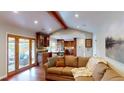 Open living room with access to the outdoors and a view of the kitchen at 6278 E Euclid Ave, Centennial, CO 80111