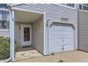 Close-up view of a townhouse showcasing the entrance, garage, and address at 12332 Colorado Blvd # 30, Thornton, CO 80241