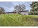 Beautiful home featuring an expansive lawn and mature trees at 10698 W 26Th Ave, Lakewood, CO 80215
