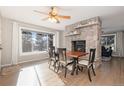 Dining area with a wood table and stone fireplace at 3980 Home St, Castle Rock, CO 80108