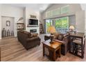 Spacious living room boasts a vaulted ceiling, a fireplace, and sliding doors to a backyard oasis at 4121 River Oaks St, Castle Rock, CO 80104
