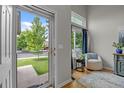 Bright entryway with hardwood floors, a decorative window, and a view of the landscaped front yard at 11188 Latigo Ln, Parker, CO 80138
