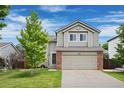 Charming two-story home with a well-maintained lawn and a two-car garage, perfect for Gathering living at 11188 Latigo Ln, Parker, CO 80138