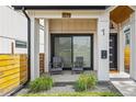 Inviting front porch with seating area, attractive landscaping, and a welcoming entryway at 1578 Lowell Blvd # 1, Denver, CO 80204