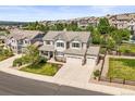 Expansive aerial view of a well-maintained home with a three-car garage and a lush backyard at 2090 Bellavista St, Castle Rock, CO 80109