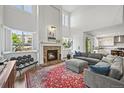 Bright living room features a cozy fireplace, large windows, and a comfortable seating area at 2090 Bellavista St, Castle Rock, CO 80109