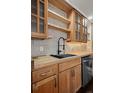 Kitchen with wood countertops, open shelving, stainless steel dishwasher, and a matte black faucet at 11651 Pennsylvania St, Northglenn, CO 80233