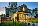Modern two-story home boasting sleek lines, dark accents, and a beautifully landscaped front yard at 516 Grant Ave, Louisville, CO 80027