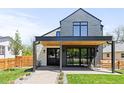Modern home exterior with a covered front porch featuring a wood ceiling and black support beams at 516 Grant Ave, Louisville, CO 80027