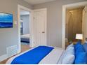 Well-lit bedroom with a blue-themed bed and a view of an adjacent bathroom at 4990 Hooker St, Denver, CO 80221
