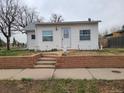 Charming single-story home featuring a neat front yard with brickwork and a sidewalk at 4990 Hooker St, Denver, CO 80221