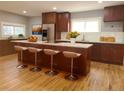Modern kitchen featuring a large island with seating and stainless steel appliances at 4990 Hooker St, Denver, CO 80221