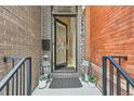 Charming front entrance with black door, brick accents, and decorative lanterns at 2846 Champa St, Denver, CO 80205