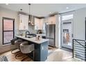 Stylish kitchen with white cabinets, stainless steel appliances, and island seating at 2846 Champa St, Denver, CO 80205