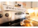 Close-up of stainless steel range with copper accents and decorative touches in the kitchen at 2548 S Zurich Ct, Denver, CO 80219